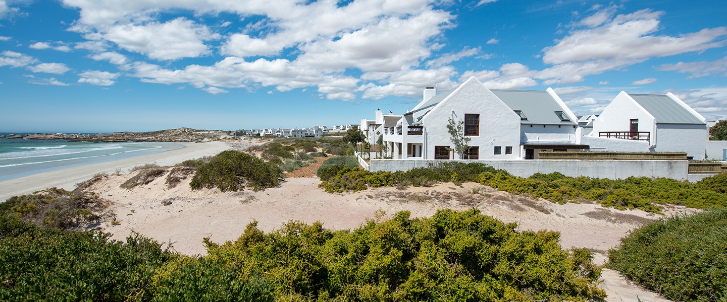 Whitewashed cottages lining the beach in Paternoster, South Africa